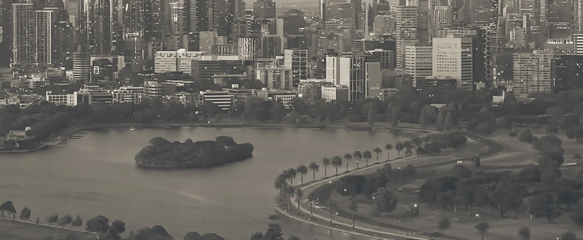 Albert Park Lake at dusk, looking north across the water to the Melbourne skyline